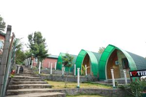 a group of buildings with stairs in front of them at The Den by Trees in Kotagiri