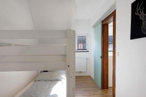 a small bedroom with a bunk bed in a house at Haus Schiltach in Schramberg +26 photos