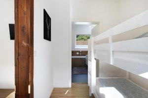 a white room with a staircase and a sink at Haus Schiltach in Schramberg