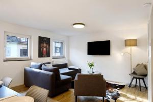 a living room with a couch and a tv at Haus Schiltach in Schramberg