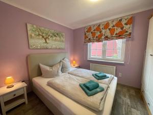 a bedroom with a bed with two pillows on it at Ferienhaus Pirol in Zossen