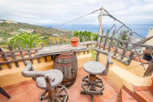 a balcony with two chairs and a wine barrel at Casa Carmela in La Guancha