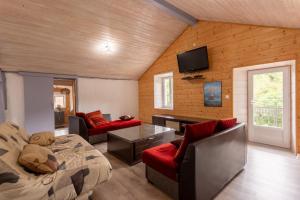a living room with a bed and a tv on the wall at Villa À Isturits Avec Piscine in Isturits