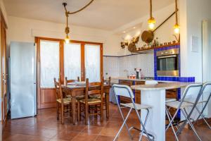 a kitchen with a large wooden table and chairs at Villa Glicine - Colleberto in Follonica