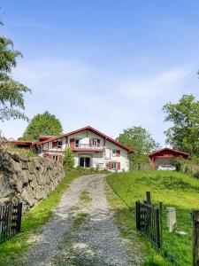 a house on a hill with a dirt road at Villa À Isturits Avec Piscine in Isturits