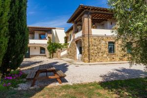 a house with a picnic table in front of it at Villa Glicine - Colleberto in Follonica