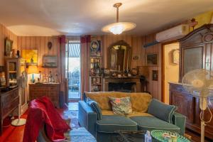 a living room with a couch and a mirror at Appartement de charme in Ruoms