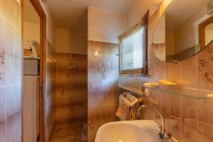 a bathroom with a sink and a toilet and a window at Appartement de charme in Ruoms +12 photos