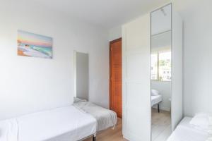 a bedroom with two beds and a mirror at Don Miguel 2 in Benidorm +25 photos
