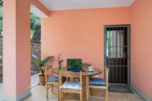 a patio with a table with a laptop on it at Casa Taggiasca in Diano Marina