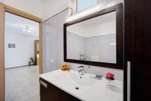 a bathroom with a sink and a large mirror at Casa Taggiasca in Diano Marina +22 photos