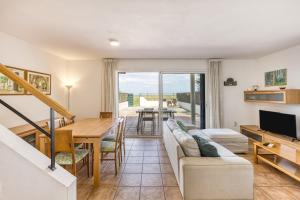 a living room with a couch and a table at Oasis Premium Costa Brava in L'Estartit