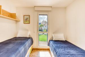 two beds in a room with a window at Oasis Premium Costa Brava in L'Estartit +31 photos