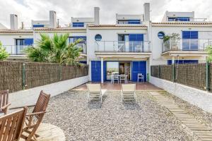 a building with chairs and a table in front of it at Oasis Premium Costa Brava in L'Estartit