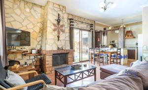 a living room with a couch and a fireplace at La Cañada in El Gastor