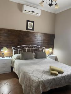 a bedroom with a large bed with a wooden headboard at La Cañada in El Gastor