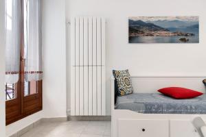a bedroom with a bed with a red pillow and a window at La piccola Lami in Intra