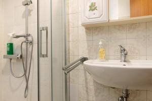 a bathroom with a sink and a shower at La piccola Lami in Intra