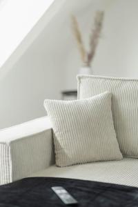 a couch with two pillows in a room at Cityloft für Stilvolle in Dessau