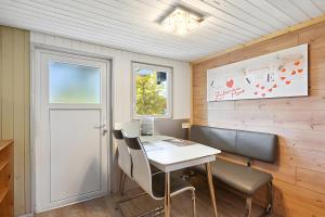 an office with a desk and chairs and a window at Ferienhaus 219 in Zadelsdorf +14 photos
