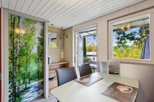 a dining room with a table and chairs and a window at Ferienhaus 219 in Zadelsdorf