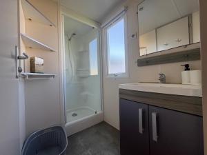 a bathroom with a shower and a sink and a mirror at Coral Bungalow in Ayamonte +12 photos