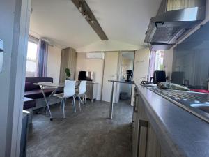 a kitchen and living room with a table and chairs at Coral Bungalow in Ayamonte