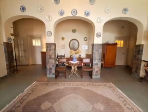 a living room with a table and chairs and plates on the wall at Huize Beukenstein in Lochem