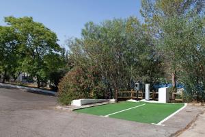 a artificial grass golf course in a parking lot at Loft Los Olivos in Algar