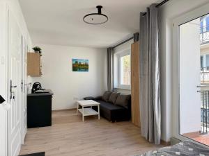 a living room with a couch and a window at Willa Karwia in Karwia