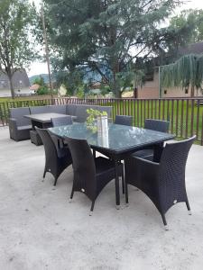 a patio table with chairs and a table with flowers on it at Gîte La Maison De Caroline, Spa in Sigolsheim +13 photos