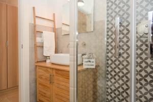 a bathroom with a sink and a shower at Trullo Delori with infinity Pool in Villa Castelli +37 photos