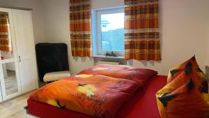 a bed sitting in a room with a window at Heim Lisse in Dietenhofen +27 photos