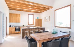 a kitchen with a wooden table and chairs at Son Sec Nou in El Palmer