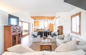 a living room with white couches and a tv at Son Sec Nou in El Palmer