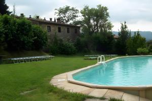 a swimming pool in a yard next to a house at Villa con parco e piscina-Camaiore in Nocchi