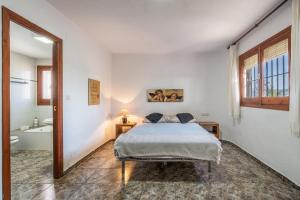 a bedroom with a bed and a bathroom with a tub at Apartamentos Villa Martinez in Salobreña +78 photos