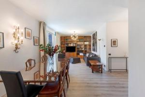 a living room with a table and chairs and a couch at Lake Como Style Home in Lecco