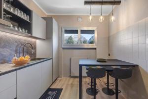 a kitchen with a blue table and two stools at Lake Como Style Home in Lecco