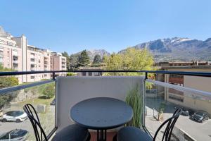 a balcony with a table and chairs and mountains at Lake Como Style Home in Lecco