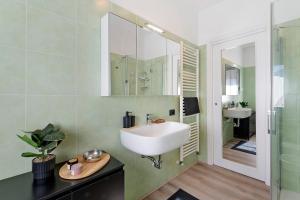 a bathroom with a sink and a mirror at Lake Como Style Home in Lecco +15 photos