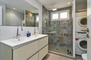 a bathroom with a sink and a washing machine at Casa Sueña in Calahonda +35 photos