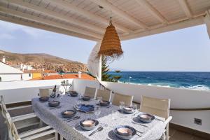 a dining table with a view of the ocean at Casa Sueña in Calahonda
