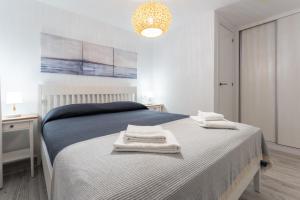 a bedroom with a bed with towels on it at Seafront Beach house Rocas del Mar in Mijas +17 photos