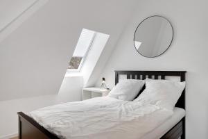 a bedroom with a bed with a mirror on the wall at Altes Forstamt in Gernsbach