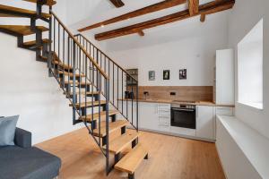a staircase in a living room with a kitchen at Altes Forstamt in Gernsbach