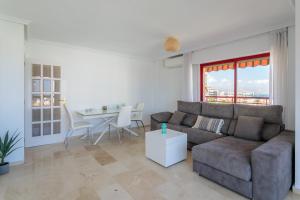 a living room with a couch and a table at Torre Mar Muchavista in El Campello