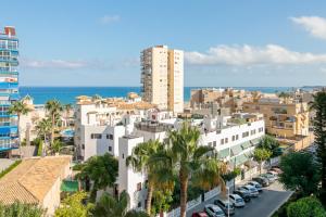 an aerial view of a city with buildings and the ocean at Torre Mar Muchavista in El Campello