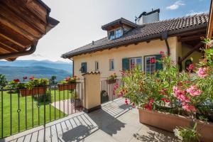 a house with a balcony with flowers at Weingut Lieselehof Apt Vitis in Caldaro