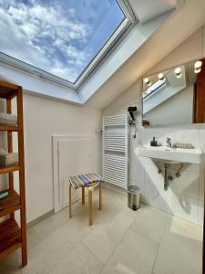 a bathroom with a skylight and a sink at Bodenseeblick in Konstanz +13 photos